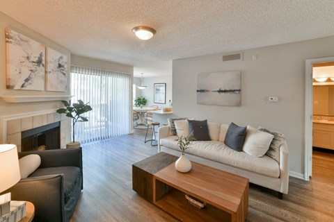 a living room with a couch coffee table and a fireplace